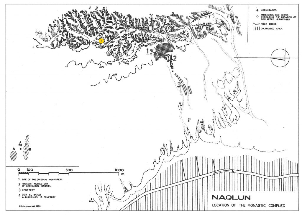 Line drawing of the site of Naqlun. The monastery is east of the mountains; to the west is a desert and then the cultivated land. A yellow dot marks the location of Hermitage 44 north of the monastery, just on the east side of the mountain.