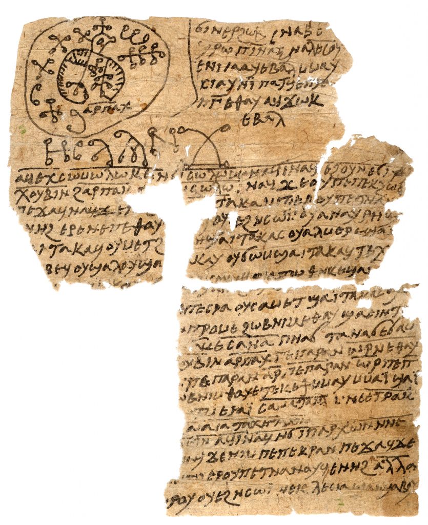 An image of a sheet of rag paper, badly damaged at the top-right and bottom-left. The sheet has Coptic writing and magical signs on it, while at the top left there is an image of a highly-stylised bird.