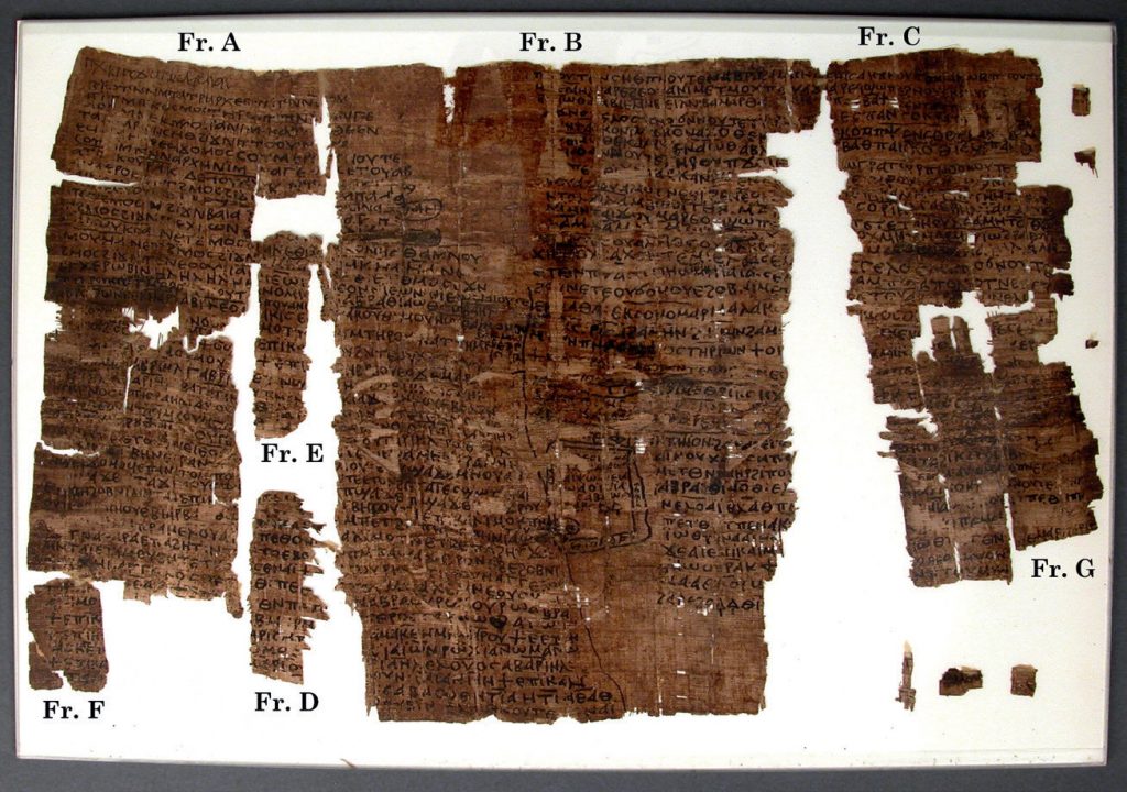 A fragmentary, dark brown papyrus, with Coptic written in two columns.