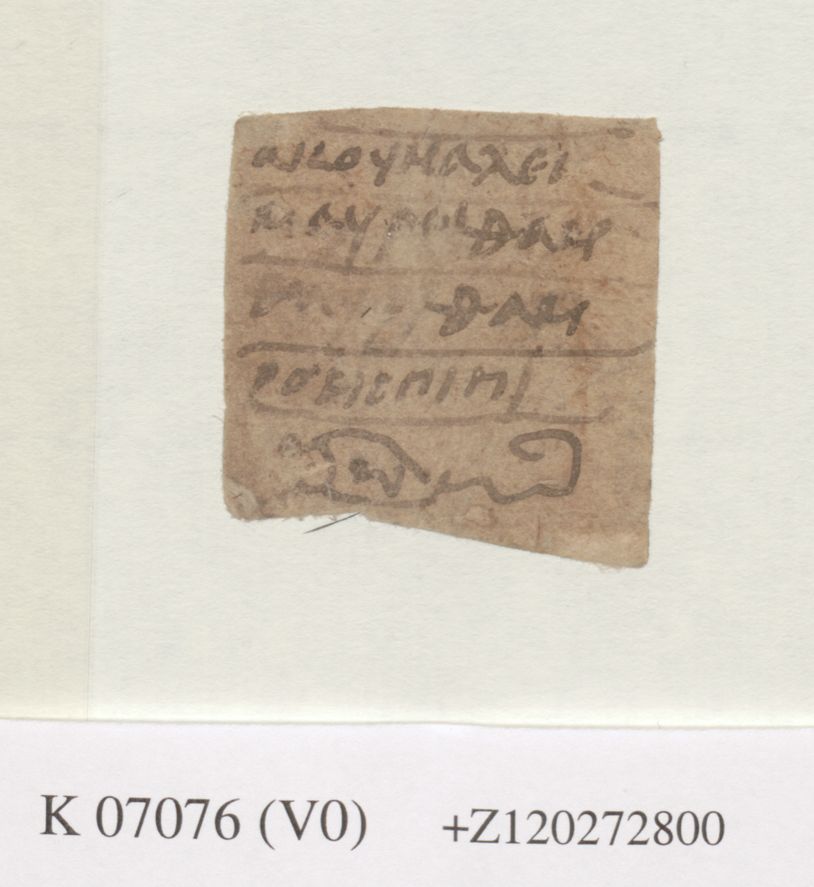 An image of a small, brownish square of paper. At the top are 4 lines of Coptic text, and below is a stylised image of a scorpion.